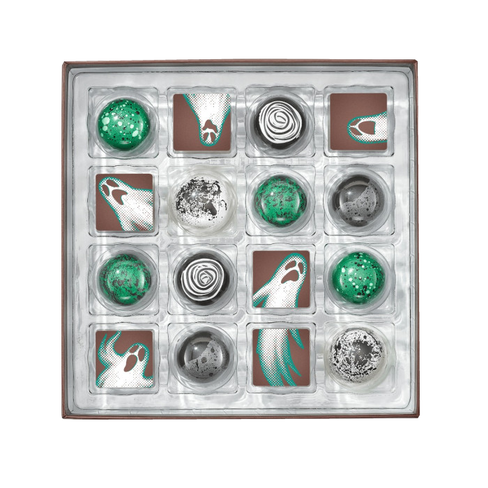 Top-down view of all sixteen decorated Christopher Elbow Haunted Halloween chocolates in the open gift box