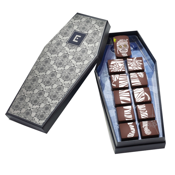 Christopher Elbow Mummy Coffin chocolate collection with eleven illustrated chocolate pieces arranged as a mummy in a coffin-shaped gift box